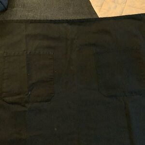 Bistro apron black, 27.5”W x 30.5” L 
Two 7” front pockets. Back tie